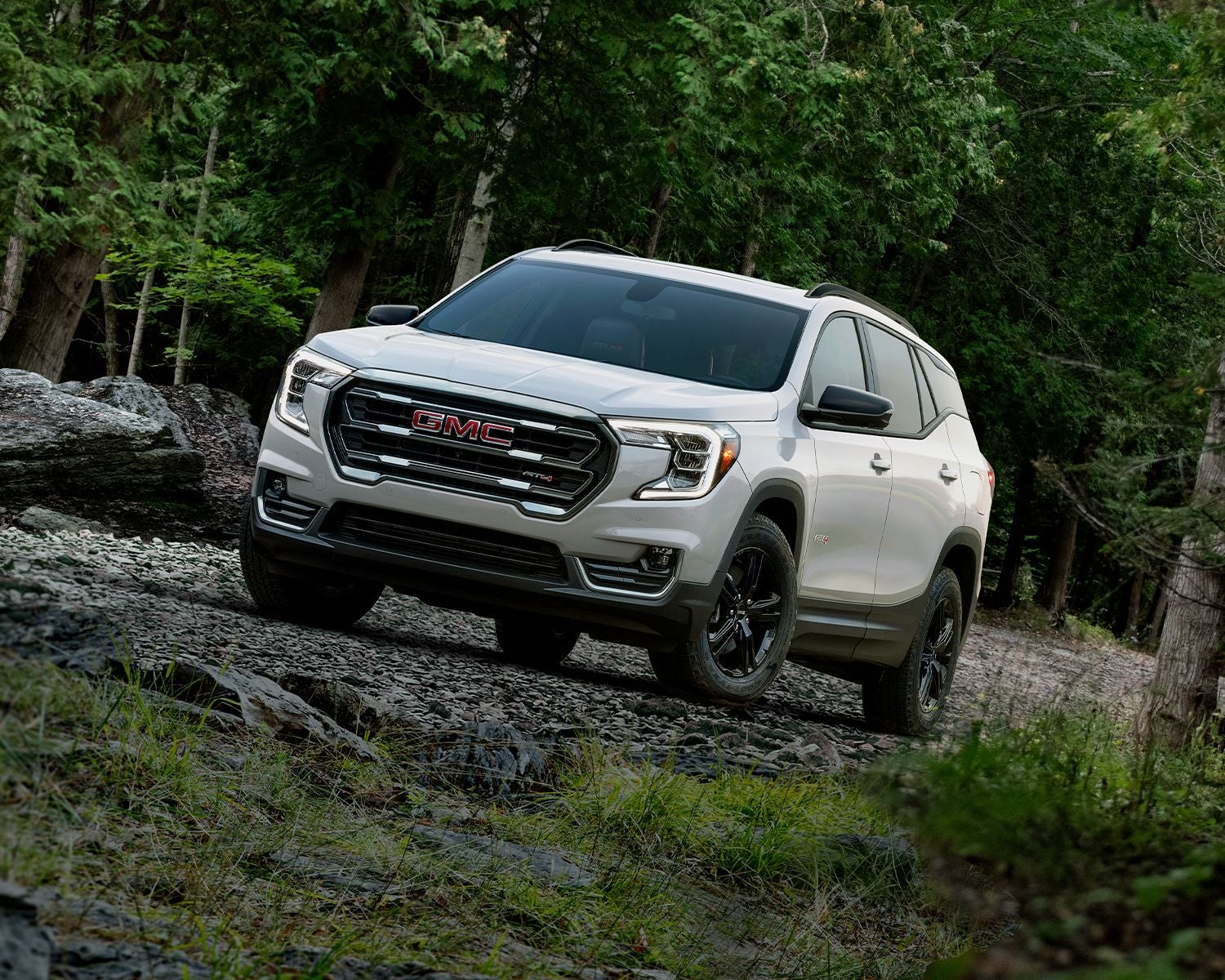 2024 GMC Terrain driving through the woods