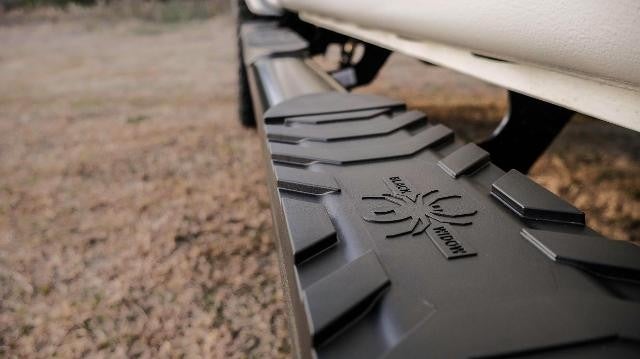 Close up view of a side step of a muddy GMC truck